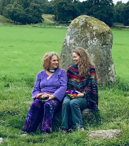 Suzannah and Ellen sitting in front of a large rock